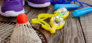 Sporting Goods Logistics - Badminton, racket, goggles, shoes, and jump rope on wood